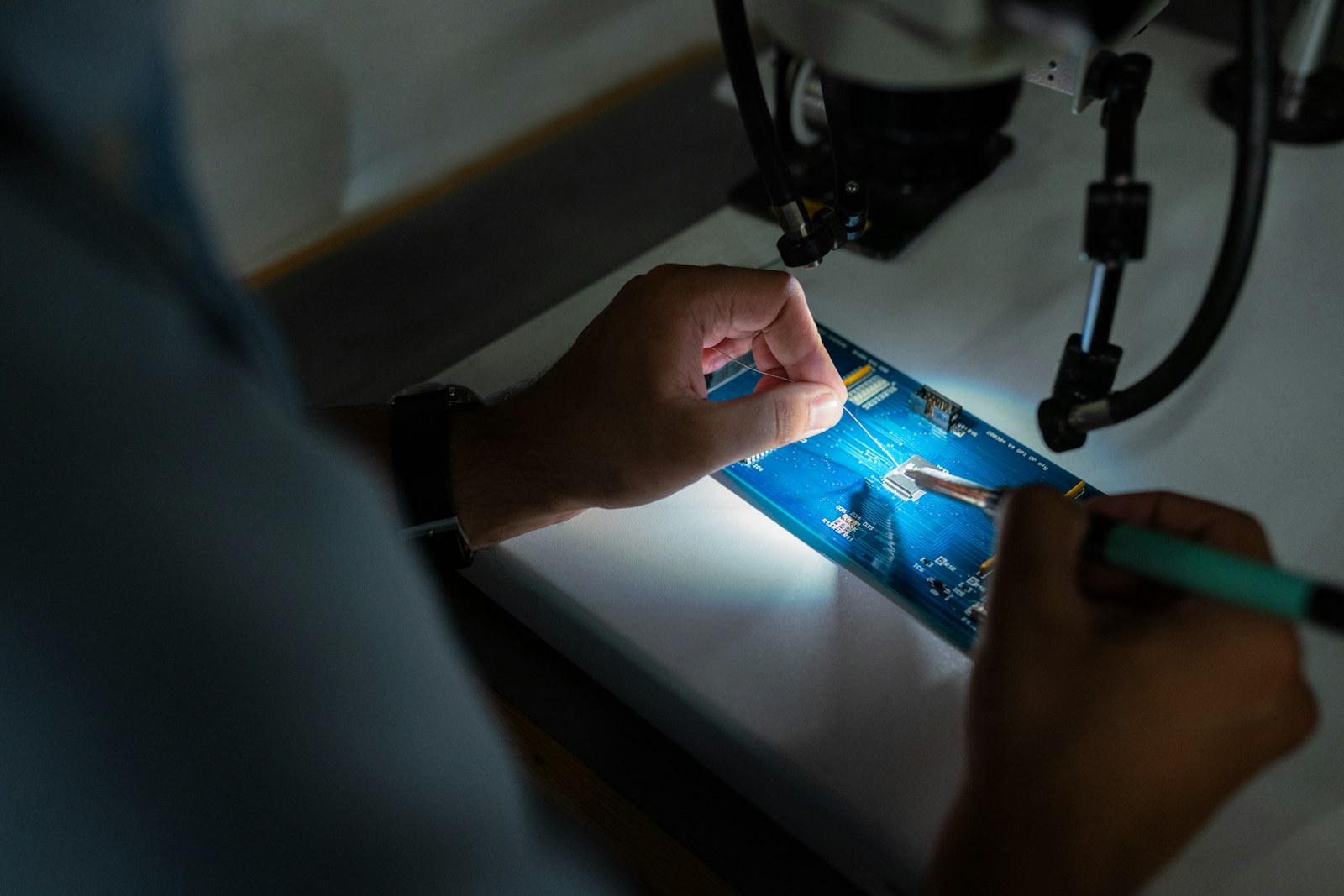 Hands working on electronic equipment